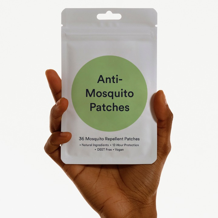 Hand holding Anti-Mosquito Patches packet for use in playgrounds and green areas
