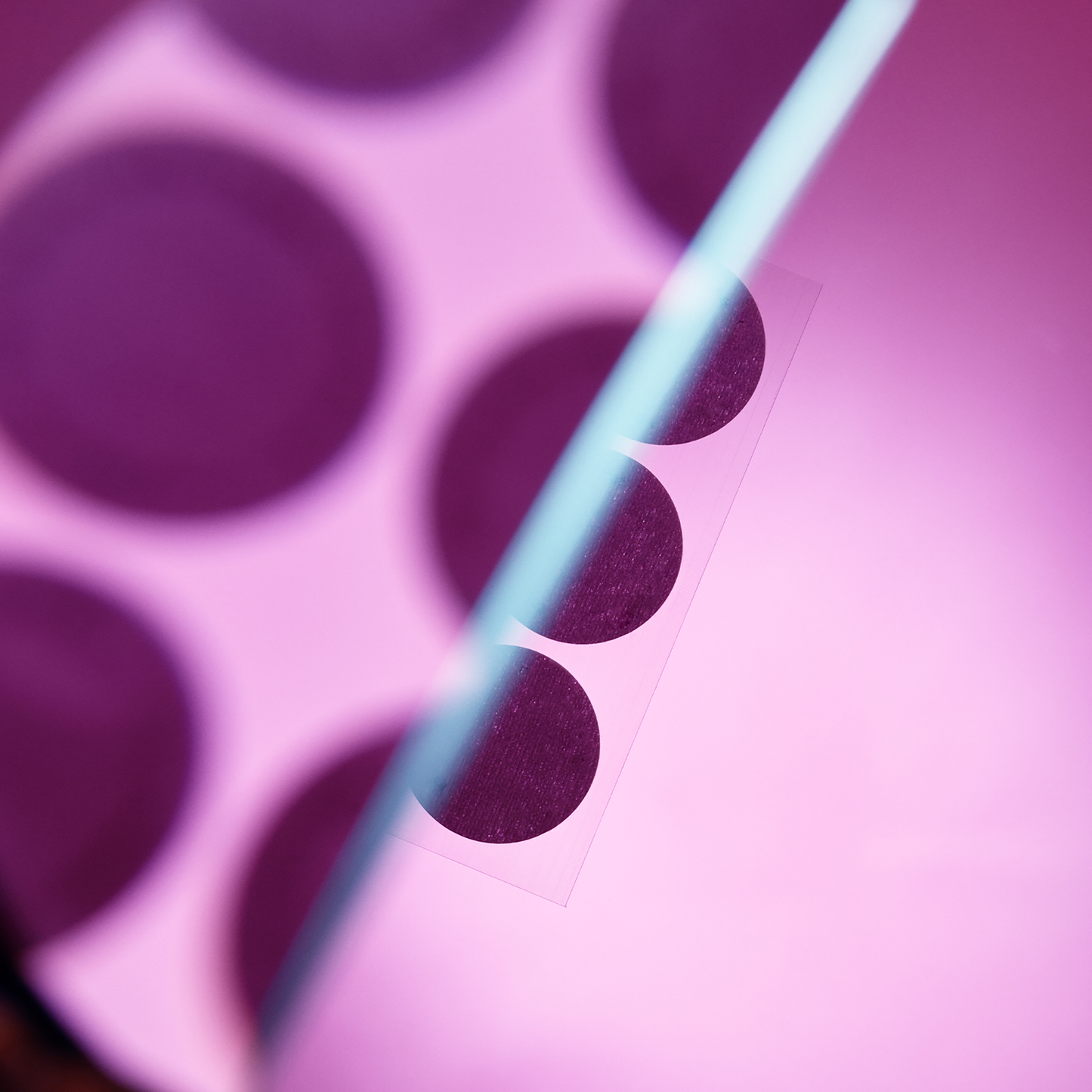 Close-up of pink Menopause Patches on backing sheet