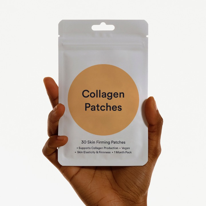 Hand holding a package of Collagen Patches against a white background
