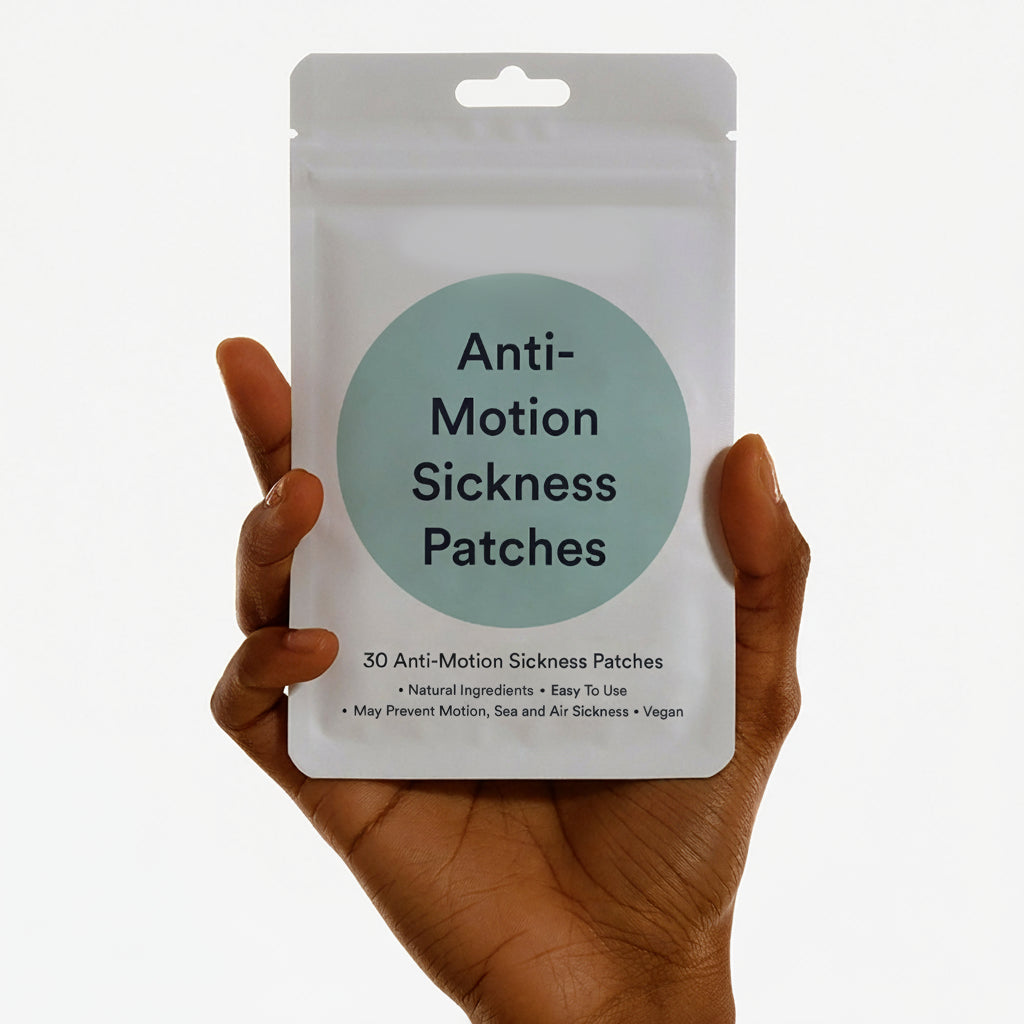 Hand holding Anti-Motion Sickness Patches packet- Ginger Root, Mint and Tangerine Peel - Easy Pre-Travel Use - 30 Count