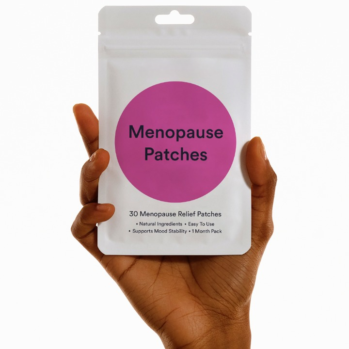 Hand holding Menopause Patches packet with herbal blend
