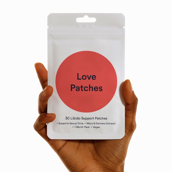 Hand holding Love Patches packet for natural libido support