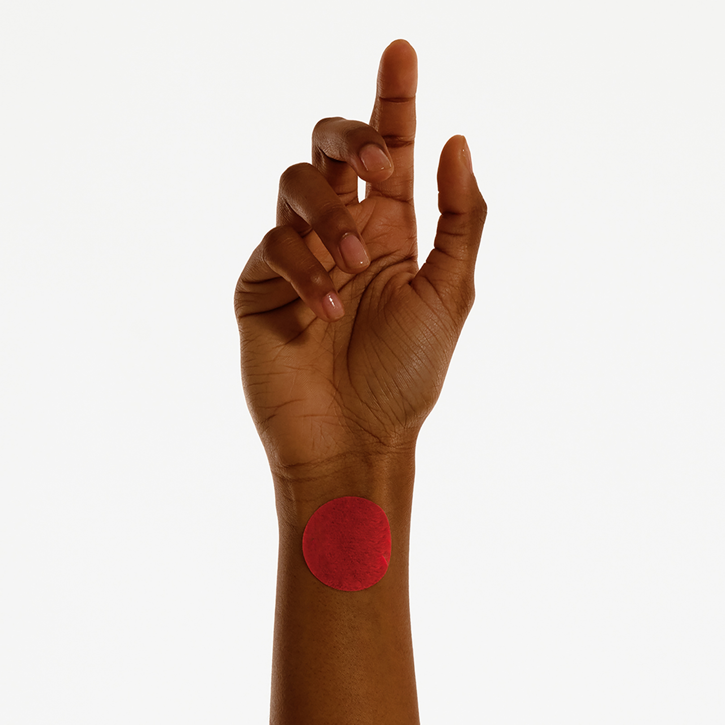 Person applying Period Relief Patch on wrist for comfort