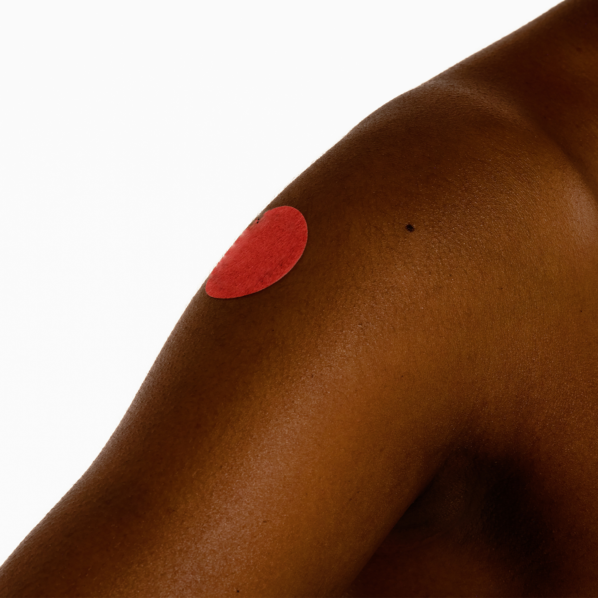 Sheet of round red Period Relief Patches for menstrual support